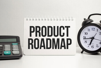 product roadmap words with calculator and clock with notebook