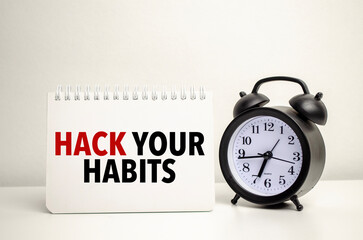 hack your habits words with clock with notebook