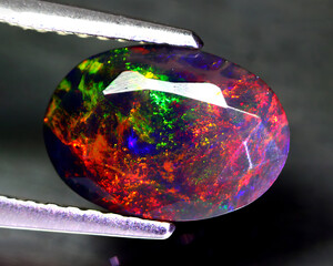 Natural beautiful gemstone opal on gray background