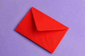 Red paper envelope on lilac background