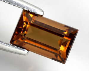 Beautiful natural gemstone imperial topaz on a gray background