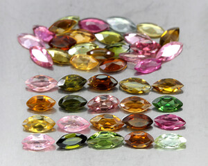 Natural beautiful gemstones multicolored tourmaline on a gray background