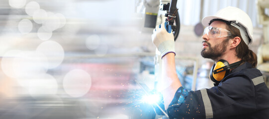 engineer checking robot welding machine - 558780398