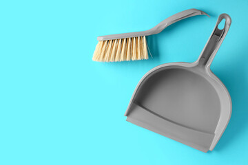 Cleaning brush and dustpan on color background