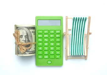 A flatlay picture of folding beach chair , retirement on calculator and roll of fake money on white...