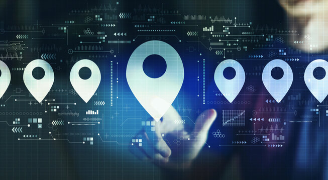 Map pin concept with young man touching a digital screen at night
