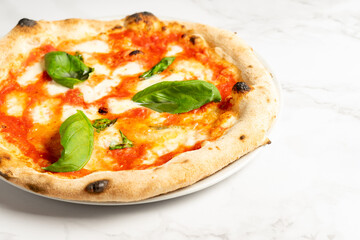 Close up of pizza with tomatoes, cheese and basil leaves. High quality photo