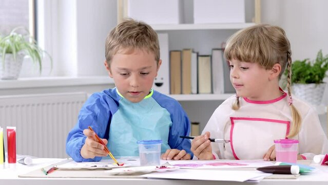 Boy and a girl are painting together