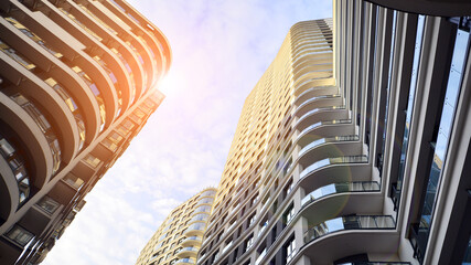 The narrow passage between modern residential buildings. Walls of high-rise apartment buildings and...