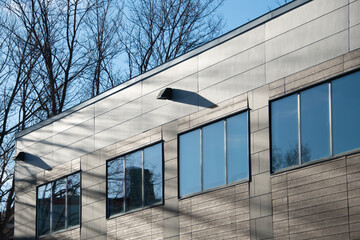 The exterior wall of a contemporary commercial style building with aluminum metal composite panels...