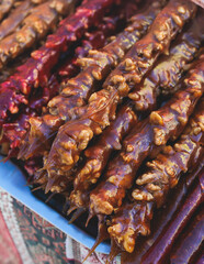 View of traditional armenian local candy sweets delights with churchkhela, sweet sausage, sudzhuk, dried fruits, walnuts and others for sale in a local vendor souvenir shop kiosk of Yerevan, Armenia