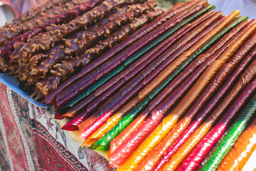 View of traditional armenian local candy sweets delights with churchkhela, sweet sausage, sudzhuk, dried fruits, walnuts and others for sale in a local vendor souvenir shop kiosk of Yerevan, Armenia