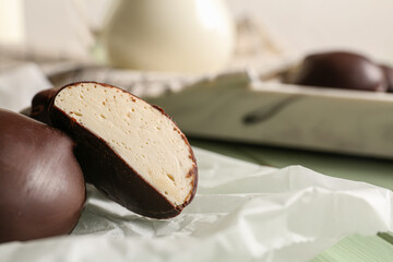 Parchment with delicious bird's milk candies on table, closeup