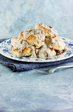 Close-up of biscuits with gravy served in plate on table at home