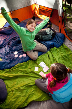 Two Young Girls Playing Cards.