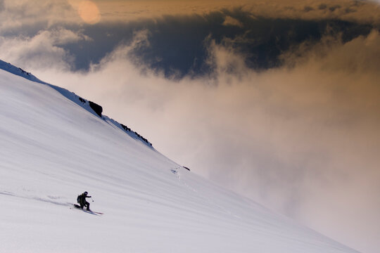 A man skiing on a glacier on Mount Vsesevidov in the Aleutian Islands in Alaska.