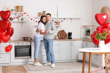 Happy couple dancing in kitchen on Valentine's Day