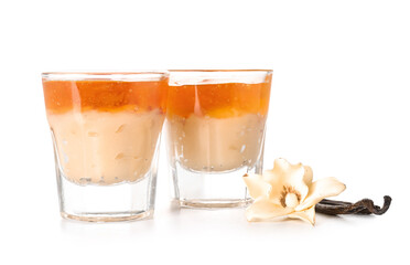 Shots of delicious pudding with jam and vanilla sticks isolated on white background