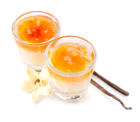 Shots of delicious pudding with jam and vanilla sticks isolated on white background