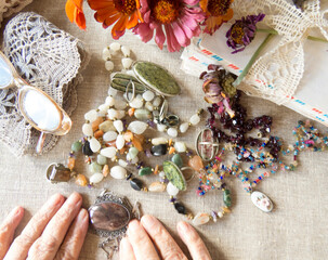 Beautiful  image of an older lady's hands   with    jewellery, bijouterie, flowers.   Memoirs,...