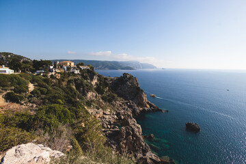 Fototapeta premium Beautiful summer aerial view of Palaiokastritsa, a village in northwestern Corfu island, Greece, with bay, Paleokastritsa monastery and Ionian sea beach in sunny day