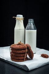 cookies and milk drinks on a black table