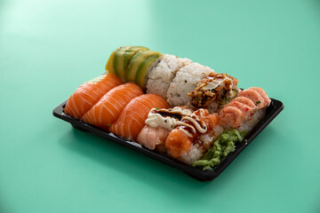 take away sushi package isolated on cyan background © Joose