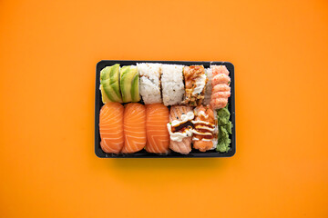 Top view of take away sushi package isolated on coloful background - Powered by Adobe