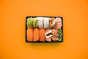 Tuinposter Top view of take away sushi package isolated on coloful background © Joose