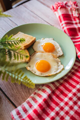 A top down and side view of eggs on the plate with toast bread on the side for breakfast clean meal healthy food 