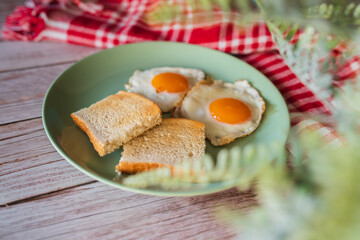 A top down and side view of eggs on the plate with toast bread on the side for breakfast clean meal healthy food 