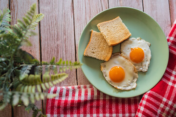 A top down and side view of eggs on the plate with toast bread on the side for breakfast clean meal healthy food 