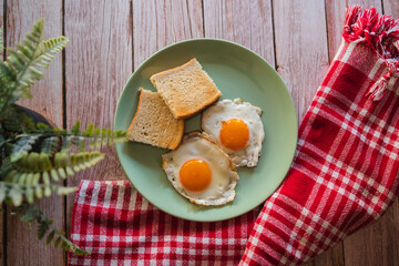 A top down and side view of eggs on the plate with toast bread on the side for breakfast clean meal healthy food 