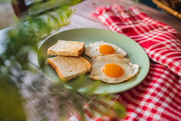 A top down and side view of eggs on the plate with toast bread on the side for breakfast clean meal healthy food 