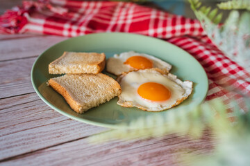 A top down and side view of eggs on the plate with toast bread on the side for breakfast clean meal healthy food 