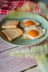 A top down and side view of eggs on the plate with toast bread on the side for breakfast clean meal healthy food 