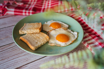 A top down and side view of eggs on the plate with toast bread on the side for breakfast clean meal healthy food 