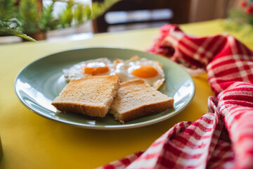 A top down and side view of eggs on the plate with toast bread on the side for breakfast clean meal healthy food 