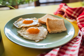 A top down and side view of eggs on the plate with toast bread on the side for breakfast clean meal healthy food 