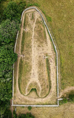 Belas Knap 5000 year Neolithic chambered long barrow near Winchcombe, UK. Cotswold Severn Cairn type. Showing burial chamber entrances and forecourt - obrazy, fototapety, plakaty