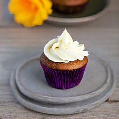 cupcake with cream, icing and sprinkles