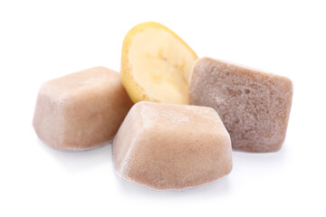 Frozen banana puree cubes and fruit on white background
