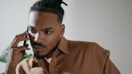 Confident businessman answering call home closeup. Dreadlocks guy talking mobile
