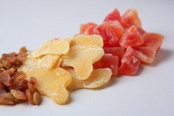 Pile of different dried fruits on white background, closeup