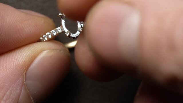 Jeweler Remove Solitaire Diamond On The Ring. - close up