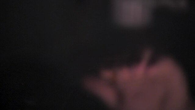 The man drops pills from his hand, enzyme, pancreatic treatment. Close-up shot on a black surface. Slowmotion. Scene A.