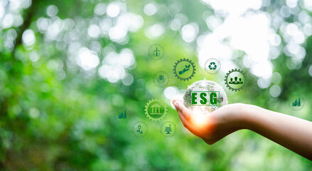 ESG icon concept in hand for environmental, social and governance in sustainable and ethical...