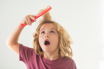 Funny kids hairstyle. Child with a comb and problem hair. Kids shampoo. Hair does not comb without a conditioner balm. - obrazy, fototapety, plakaty