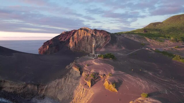 Drone push in toward Ponta dos Capelinhos lighthouse, Faial Island coastline
