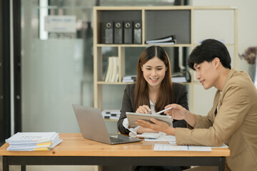 Fototapeta premium Group of asian business people working, discussing new projects together, having fun at the office.